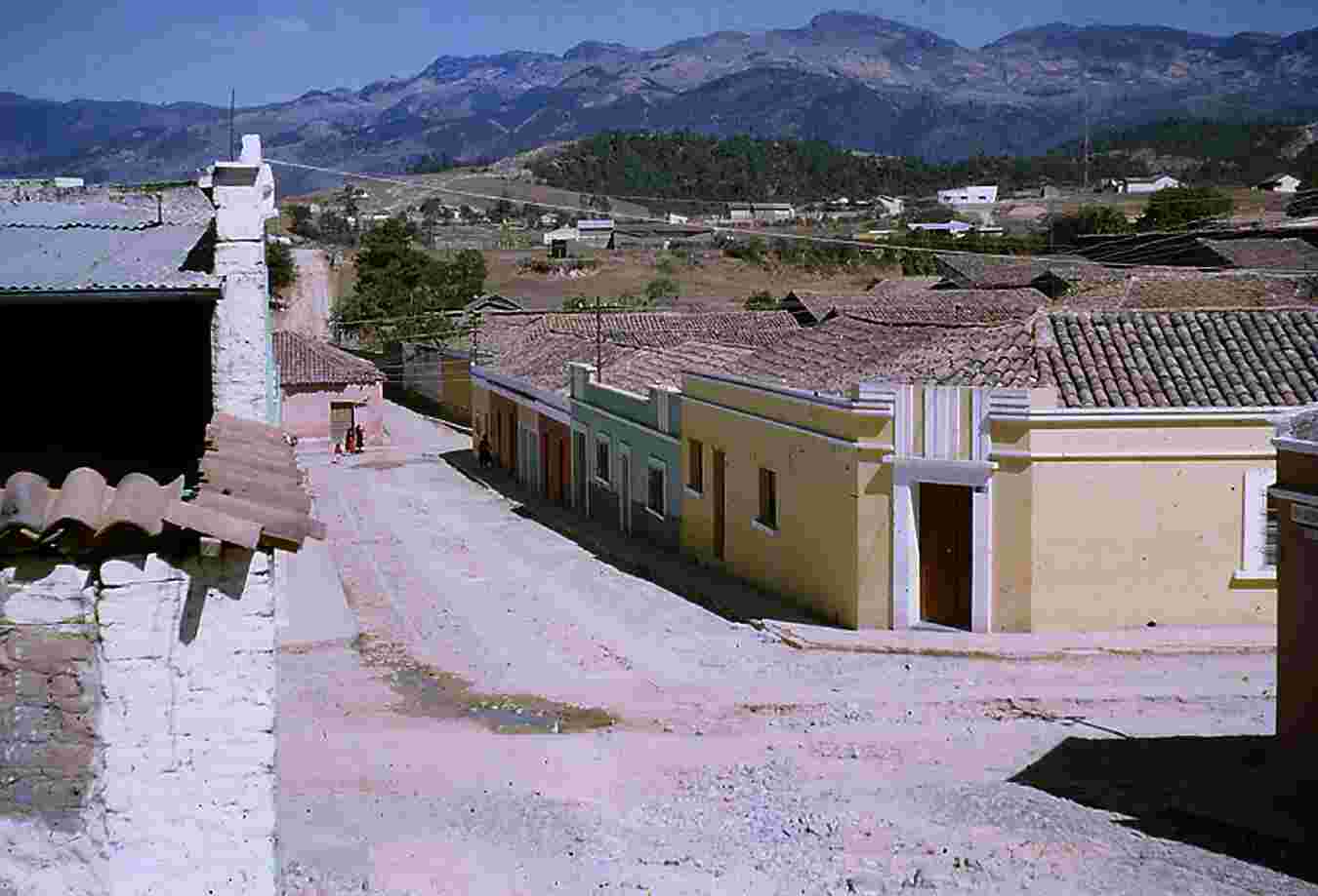 Figure 1.9. Huehuetenango. The yellow house on the corner (with a door and two windows) was my home and project headquarters, shared with Francisco Santizo Andrés. In the background, the Cuchumatán Mountains. Photo by the author.