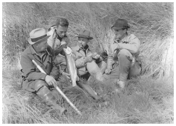 Image: Frank Dufresne (left), Corey Ford, Alistair MacBain, and Field & Stream editor Dan Holland examining rainbow trout, upper Newhalen River, Bristol Bay drainage, June 1940. By Dan Holland. Courtesy Jean T. Holland and National Park Service/Lake Clark. Dufresne and others in the Alaska Game Commission maintained close ties to the outdoor sporting community.