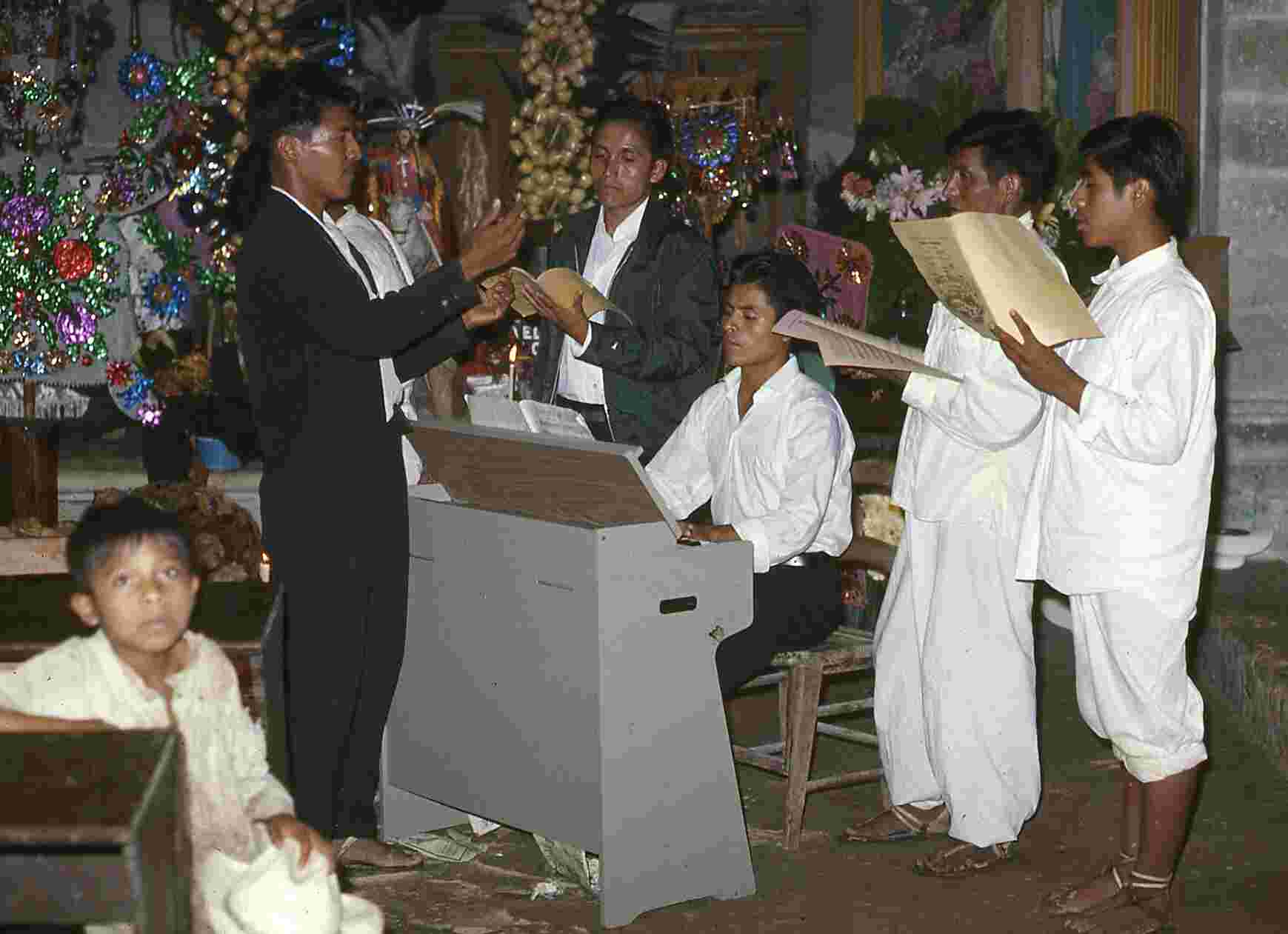 Figure 7.1. Nacho singing and standing to the right of the organist in the church on Christmas in 1969.