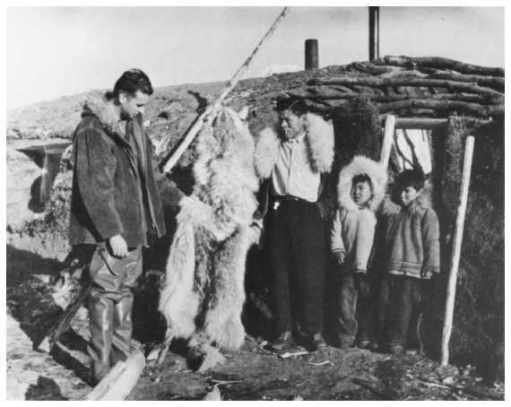 Image: U.S. Fish and Wildlife Service agent Jim King and Nunamiut Eskimos examine a wolf pelt, Anaktuvuk Pass, mid-1950s. By J. Malcolm Greany. Alaska Game Commission, 18th Annual Report, July 1, 1956 Thru June 30, 1957. A waterfowl expert, King remained active in environmental concerns for half a century.