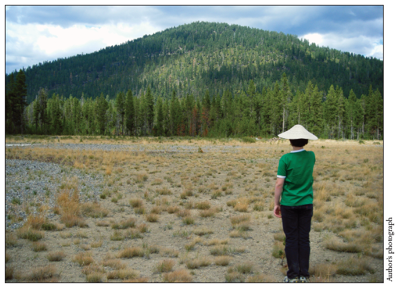 Image: Fig. 7-2. Nick Yehnert wears a “coolie hat” as he gazes at the aptly named China Hat in Deschutes County, Oregon, in September, 2010.