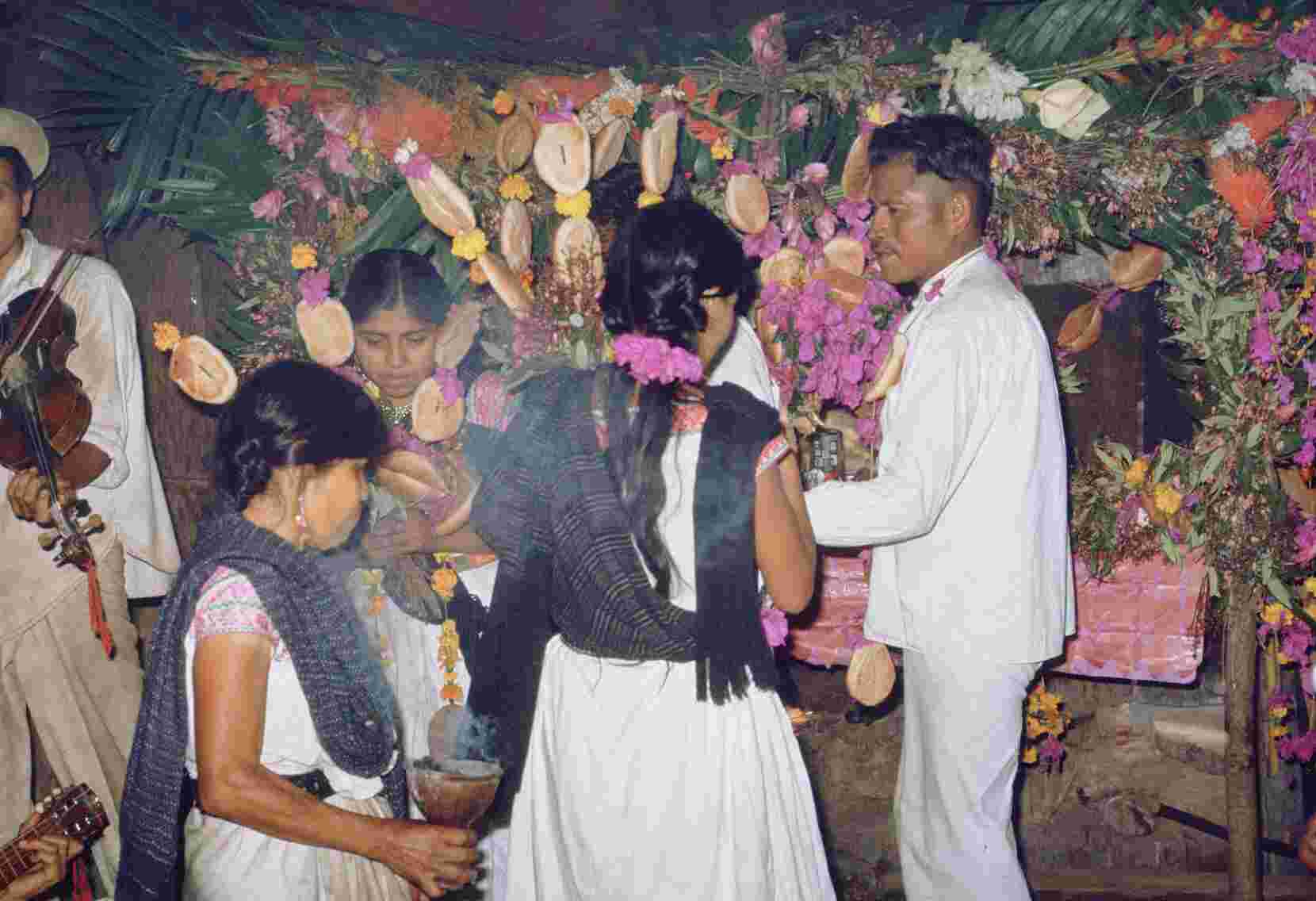 Figure 9.1. The bride and groom and their godparents of marriage perform the dance of four or nanahuin as the intermediary weaves them together with incense.