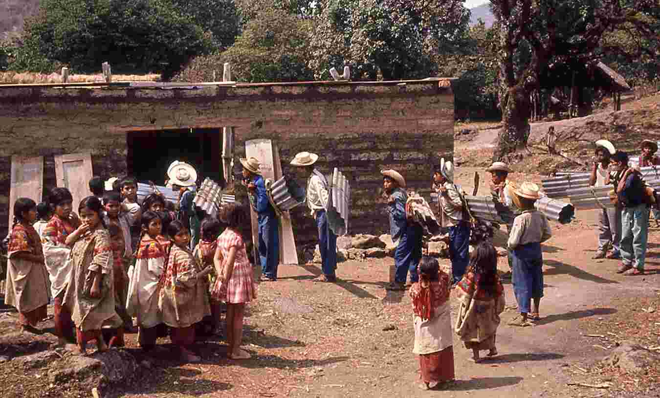 Figure 1.13. During our dialect survey, tin roofing arrives for the new Catholic church in the aldea of Xubojasun (xub’oj asun, “breath of the clouds”), municipio of Nentón. May 1965. Photo by the author.