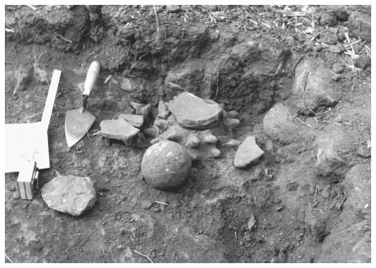 Image: FIGURE 3.15 Structure 306-86, photograph of the in situ deposit containing a nearly complete spiked incensario and stone sphere